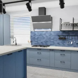 Projekt kuchni o powierzchni 15 m2 z niebieskimi frontami szafek, białym blatem i ceglastymi płytkami na ścianie, oświetlona reflektorami sufitowymi.