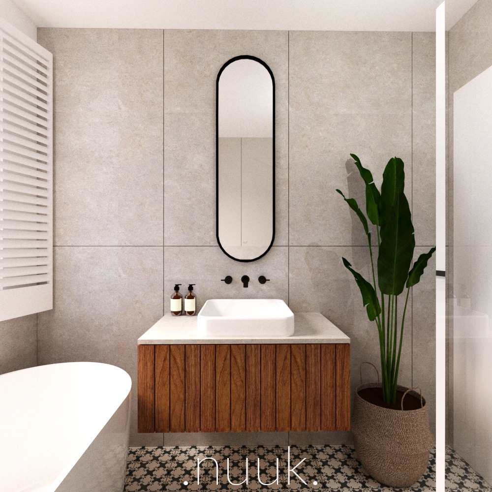 Nowoczesna łazienka z drewnianą szafką pod umywalką, owalnym lustrem w czarnej ramie, beżowymi płytkami i rośliną w plecionym koszu, widoczna część białej wanny.