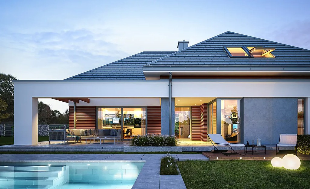 Nowoczesny dom jednorodzinny z basenem, tarasem z meblami ogrodowymi i oknami dachowymi, widok o zmierzchu.