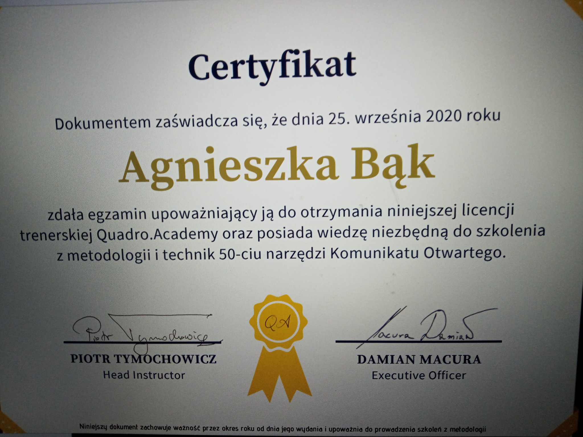 Skan certyfikatu ukończenia szkolenia z komunikacji otwartej, wydany 25 września 2020 roku dla Agnieszki Bąk, podpisanego przez Piotra Tymochowicza i Damiana Macurę, działających w Krakowie.