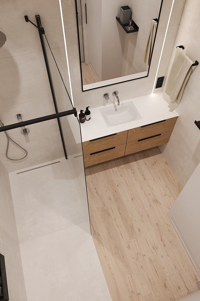 Nowoczesna łazienka po remoncie: kabina prysznicowa typu walk-in z czarnymi elementami, umywalka z szafką z drewnianym frontem i jasna podłoga. Widok z góry.