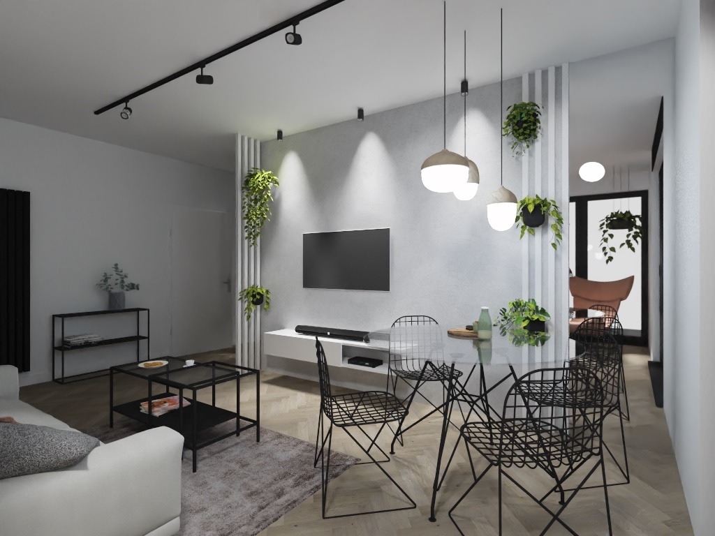 Nowoczesny salon z białą sofą, szklanym stołem jadalnym otoczonym czarnymi krzesłami drucianymi, wiszącymi lampami i roślinami doniczkowymi, oświetlenie szynowe na suficie.