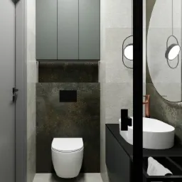 Wizualizacja nowoczesnej łazienki z podwieszaną toaletą, umywalką nablatową na czarnym blacie, okrągłym lustrem z miedzianą armaturą i szarą szafką wiszącą.