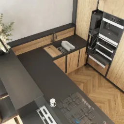 Wnętrze kuchni z wyspą, czarne blaty, drewniane szafki, zabudowany sprzęt AGD, parkiet w jodełkę, widok z góry.