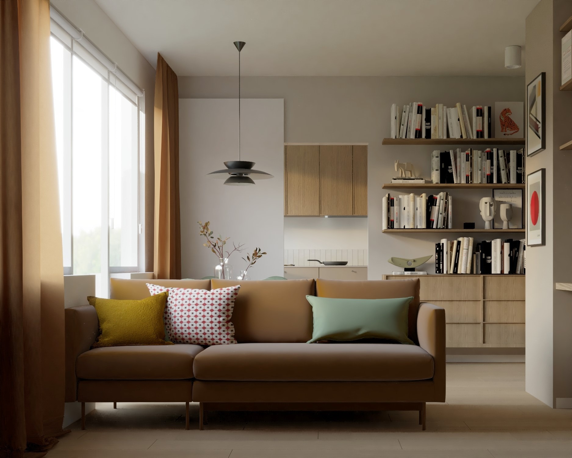 Jasny salon z brązową sofą, kolorowymi poduszkami, regałami z książkami i otwartą kuchnią w tle, oświetlony wiszącą lampą.