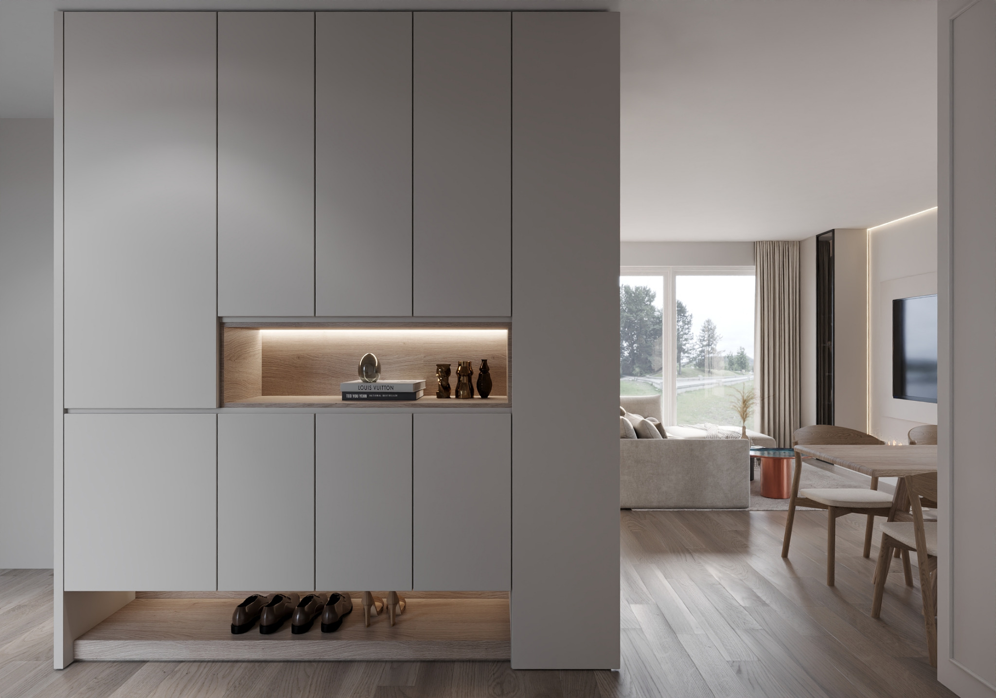 Szara szafa wnękowa z oświetleniem LED, półką na buty i dekoracjami, widok na salon z jadalnią i oknem na zewnątrz.