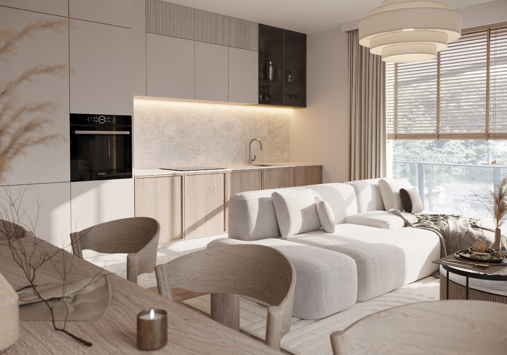 Jasne wnętrze mieszkania z aneksem kuchennym, drewnianym stołem, białym narożnikiem i dużym oknem z żaluzjami.