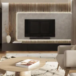 Nowoczesny salon z drewnianą ścianą, telewizorem, beżowym fotelem i okrągłym stolikiem kawowym z książką. Na podłodze leży otwarty laptop.