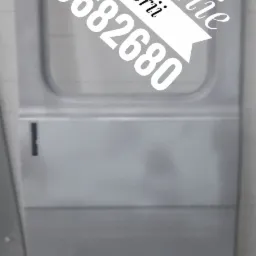 Drzwi samochodu dostawczego po sodowaniu karoserii, z nałożonym logo firmy i numerem telefonu.