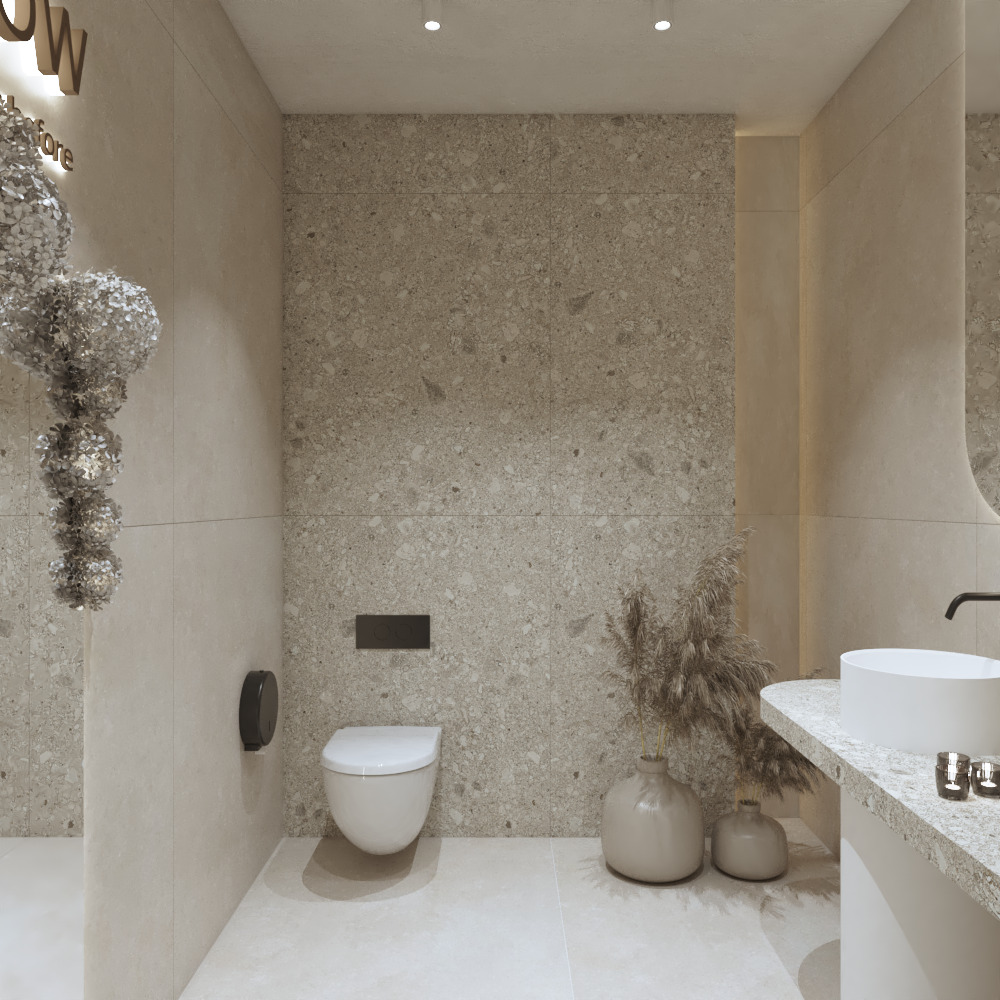 Nowoczesna łazienka z toaletą podwieszaną, umywalką nablatową i ścianą wykończoną płytkami imitującymi lastryko. Dekoracyjne wazony z suszem dodają wnętrzu przytulności.