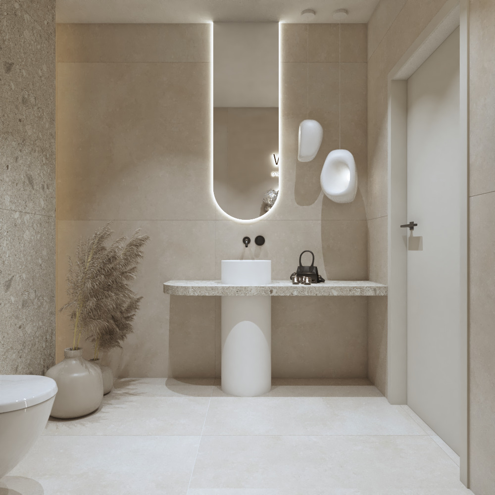Minimalistyczna łazienka w beżach: owalne lustro z podświetleniem LED, umywalka na postumencie, dekoracyjne trawy w wazonie i designerskie oświetlenie ścienne.