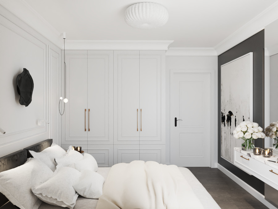 Jasna sypialnia z dużym łóżkiem, białą szafą w zabudowie z minimalistycznymi uchwytami i abstrakcyjnym obrazem w czarno-białej tonacji. Całość dopełnia designerska lampa.
