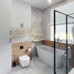 Sebastian Drelichowski - Nowoczesna łazienka z wanną wolnostojącą, toaletą podwieszaną i szarą marmurową okładziną. Drewniane akcenty i minimalistyczne półki dodają ciepła. Kabina prysznicowa ze szkła.
