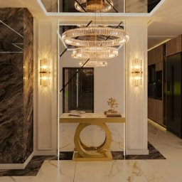 Sebastian Drelichowski - Ekskluzywny hol z marmurową podłogą i kryształowym żyrandolem we Wrocławiu. Nowoczesny design z elementami złota i eleganckimi lampami ściennymi.