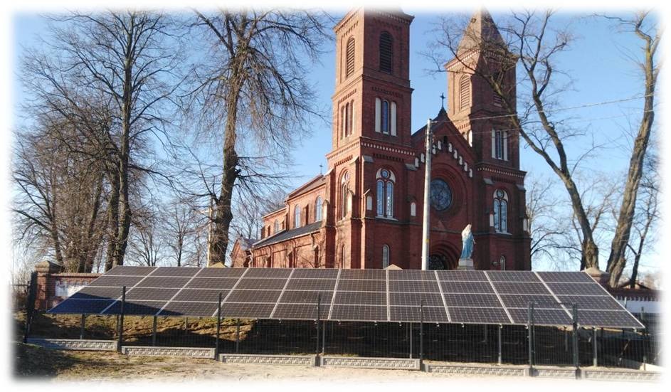 Panel słoneczny na tle ceglanego kościoła z dwiema wieżami, widok z przodu, błękitne niebo.