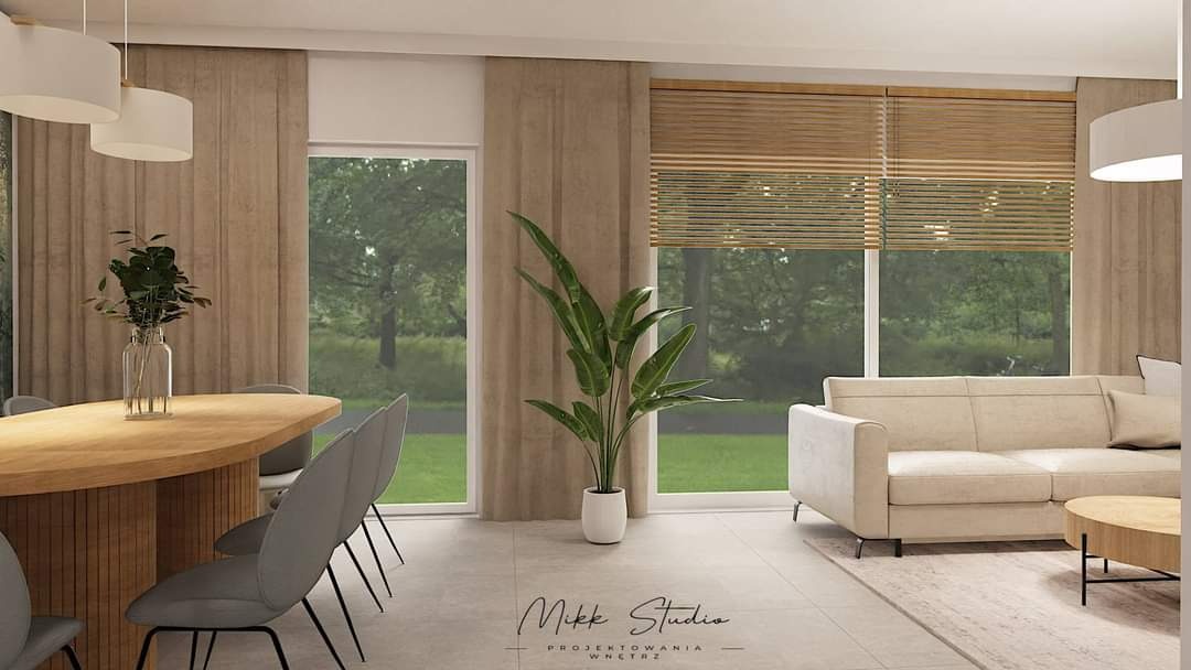 Wizualizacja salonu z jadalnią: owalny stół z krzesłami, beżowa sofa, rolety bambusowe, duża roślina doniczkowa i stonowana kolorystyka.