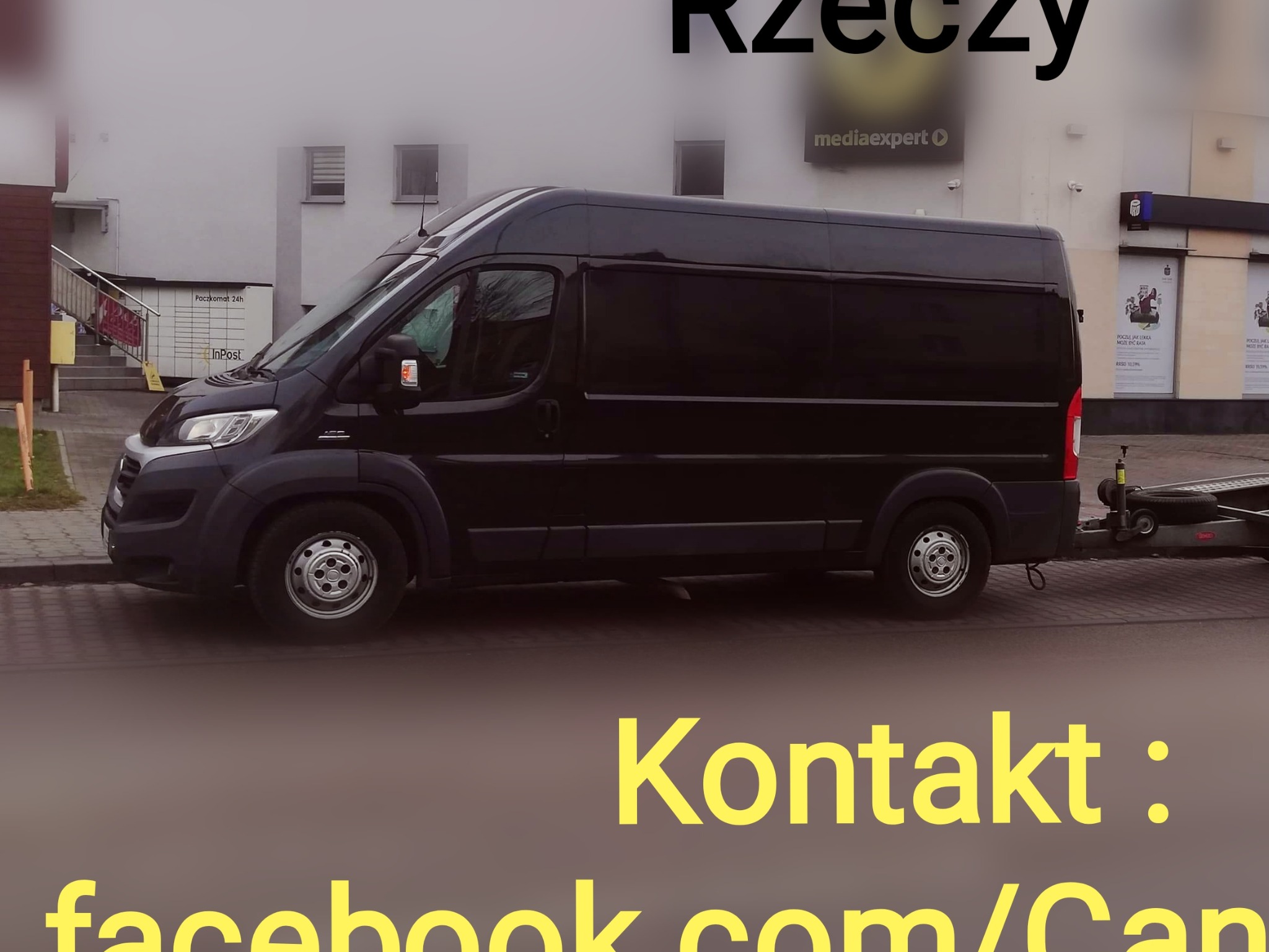 Czarny bus dostawczy z przyczepą na tle budynku z Paczkomatem i reklamami, z widocznym adresem facebook.com/CandyTrans.