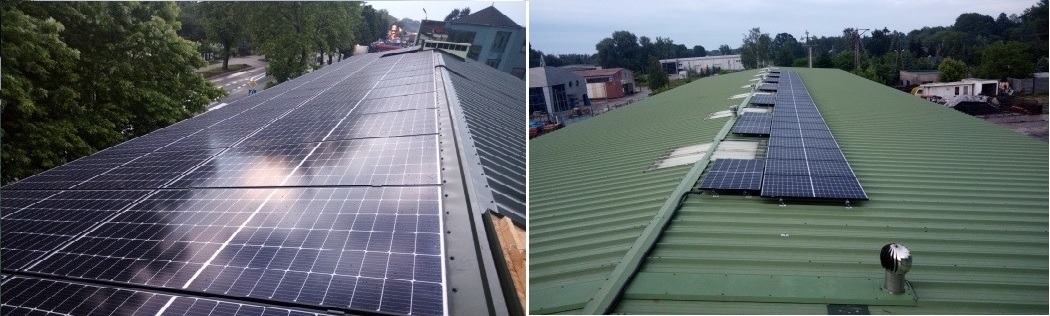 Panele słoneczne zamontowane na dachu budynku przemysłowego, widoczne odbicia w panelach i otoczenie z drzewami i zabudowaniami.