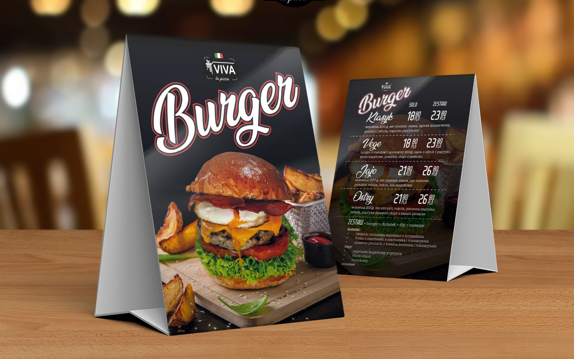 Dwa stojaki reklamowe z menu burgerów, z apetycznym zdjęciem burgera z jajkiem sadzonym na pierwszym planie, na drewnianym stole.