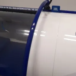 Komora hiperbaryczna Oxyhelp Industry z widocznym wnętrzem i napisem ostrzegawczym nad uszczelką.