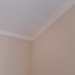 Remonty I Wykończenia Karol Szczęsny - Pomieszczenie po malowaniu, widoczny narożnik ścian z zamontowaną białą listwą dekoracyjną pod sufitem.