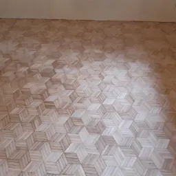 Ułożona podłoga z parkietu w geometryczny wzór kostki 3D, widok z góry, surowy stan przed lakierowaniem.