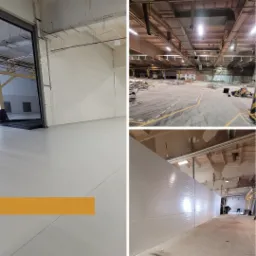 Wnętrze hali produkcyjnej przed i w trakcie remontu, z widoczną nową, białą ścianą działową z paneli na tle surowego, nieodnowionego obszaru.