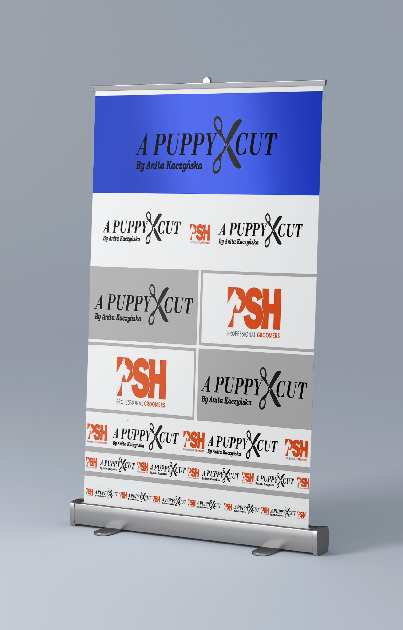 Roll-up reklamowy z logo i nazwą firmy 'A Puppy Cut' oraz 'PSH Professional Groomers' na szarym tle, prezentujący branding salonu groomerskiego.