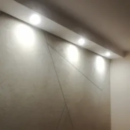 Efekt betonu dekoracyjnego z zabudową LED i halogenami