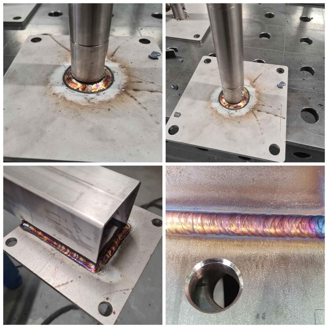 Zbliżenie na spawy łączące metalowe elementy, widoczne opalizujące przebarwienia termiczne na stali nierdzewnej, różne ujęcia spawanych konstrukcji na warsztatowym stole z otworami.