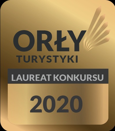 Złota odznaka 'Orły Turystyki' z napisem 'Laureat Konkursu 2020' na czarnym tle.
