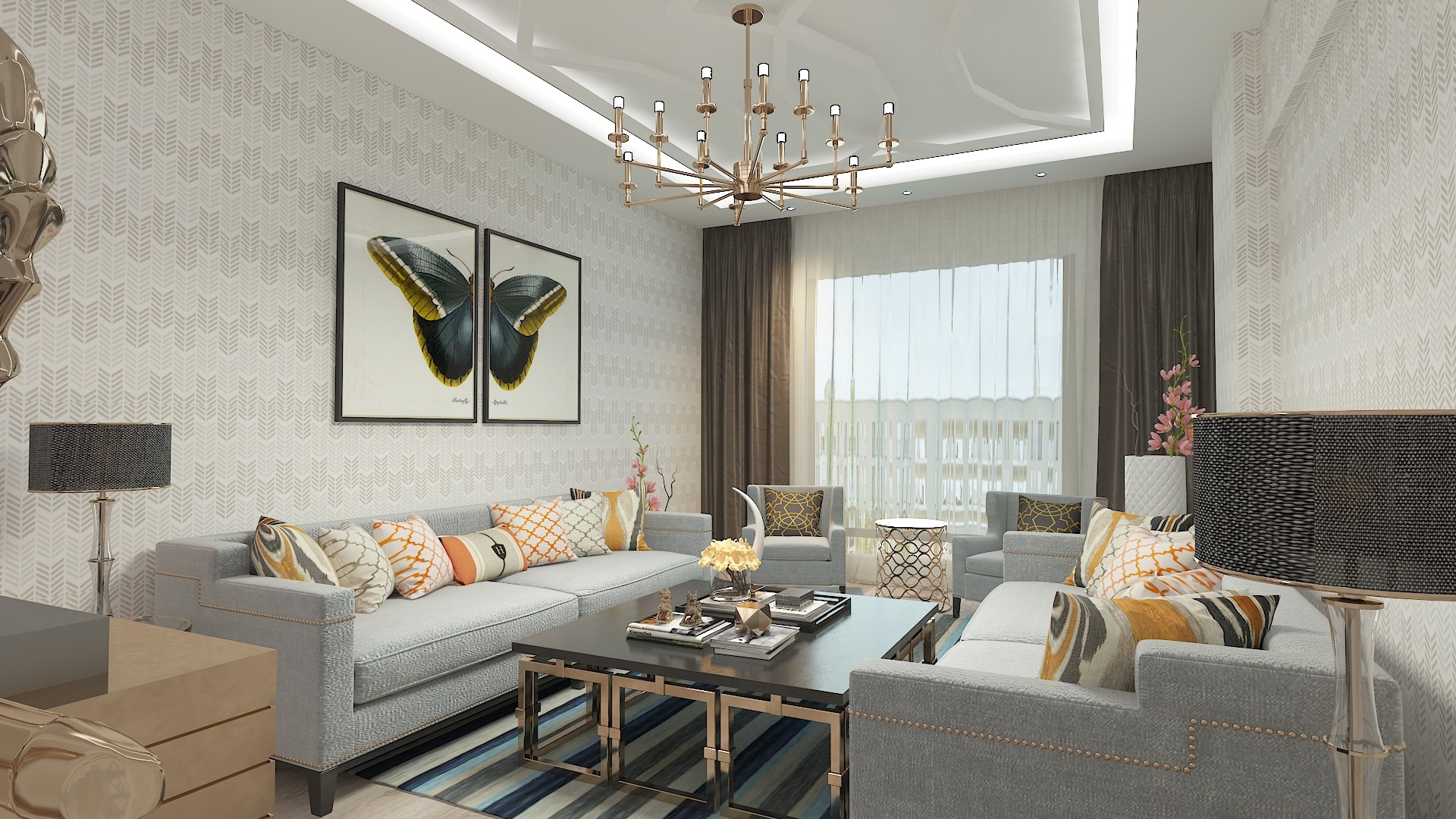 Jasny salon z szarymi sofami, wzorzystą tapetą, obrazami motyli i nowoczesnym żyrandolem.
