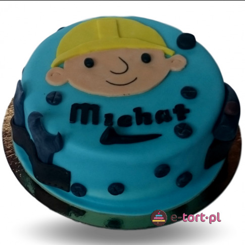 Tort urodzinowy z niebieskim lukrem, dekorowany podobizną Boba Budowniczego i imieniem 'Michał' wykonanym z ciemnego lukru.