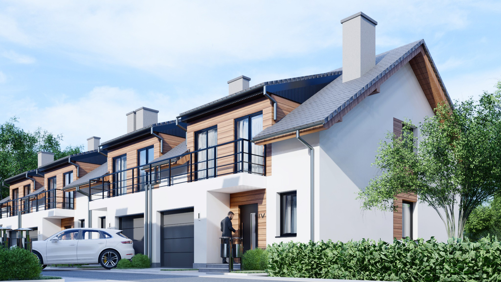Wizualizacja szeregu nowoczesnych domów z garażami, wykończonych drewnem i białym tynkiem, z balkonami z czarnymi balustradami, na tle błękitnego nieba i zieleni, osoba w garniturze stoi przed...