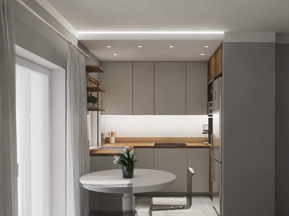 Nowoczesna, mała kuchnia w odcieniach szarości i drewna z okrągłym stołem i bukietem białych tulipanów, oświetlona listwą LED pod szafkami i punktowymi lampami sufitowymi.