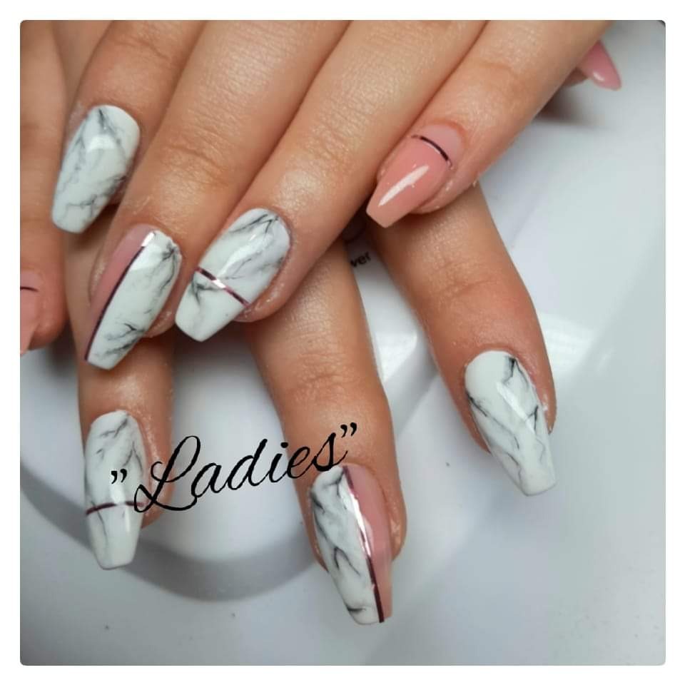 Dłonie z przedłużonymi paznokciami, stylizacja marmurkowa w odcieniach bieli i szarości, akcenty w kolorze pudrowego różu i cienkie, metaliczne paski.