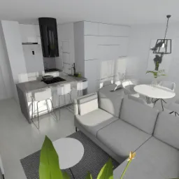 Wizualizacja nowoczesnego, jasnego wnętrza mieszkania z otwartą kuchnią, szarym narożnikiem, białym stołem i krzesłami, oraz elementami dekoracyjnymi jak rośliny i obrazy na ceglanej ścianie.