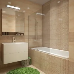 Jasna łazienka z beżowymi płytkami, białą wanną z parawanem, umywalką z szafką i puszystym zielonym dywanikiem.
