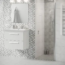 Nowoczesna łazienka z mozaikową ścianą, białymi meblami pod umywalką, kabiną prysznicową ze szklanymi drzwiami i chromowanymi detalami.