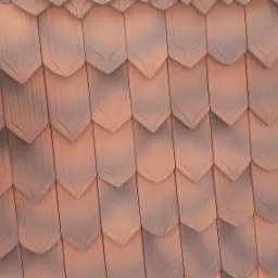 Nowe, brązowo-czerwone dach&oacute;wki ceramiczne w kształcie łuski, ułożone na dachu, widoczne drewniane elementy konstrukcyjne i siatka wentylacyjna przy okapie.