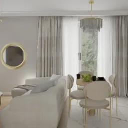 Wnętrze w beżach: sofa narożna z poduszkami, okrągłe lustro i stolik kawowy z marmurowym blatem. W tle stół z krzesłami i zabudowa kuchenna.
