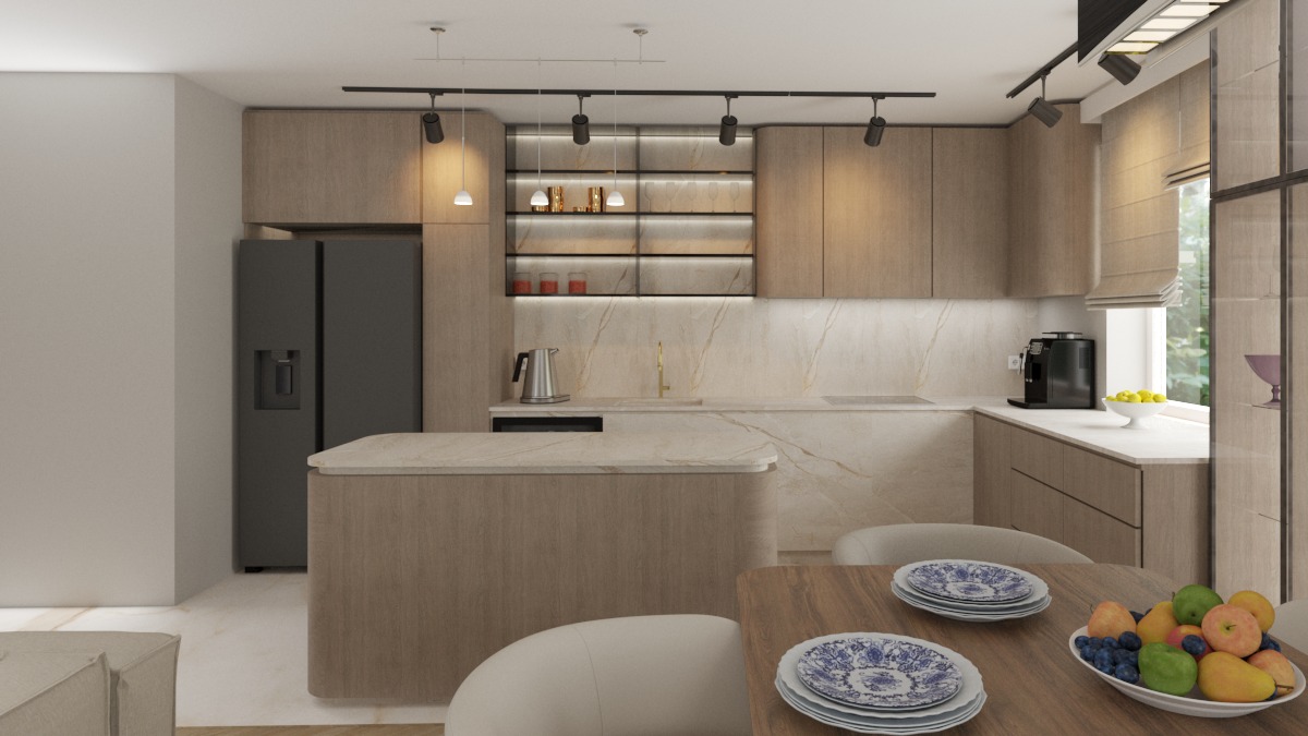 Nowoczesna kuchnia w beżach z wyspą, oświetleniem punktowym i marmurowym blatem. Na stole talerze z niebieskim wzorem i misa owoców. Minimalistyczny design.