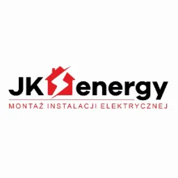 Logo firmy JK Energy z Warszawy, specjalizującej się w montażu instalacji elektrycznej. Logo przedstawia stylizowany dom z symbolem błyskawicy w kolorze czerwonym, obok napis 'energy'. Pod spodem...