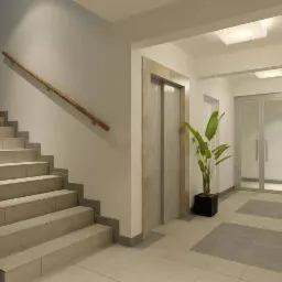 Jasne, nowocześnie wykończone wnętrze klatki schodowej z windą, schodami z metalową balustradą i drewnianym poręczą, rośliną doniczkową oraz dwuskrzydłowymi drzwiami.