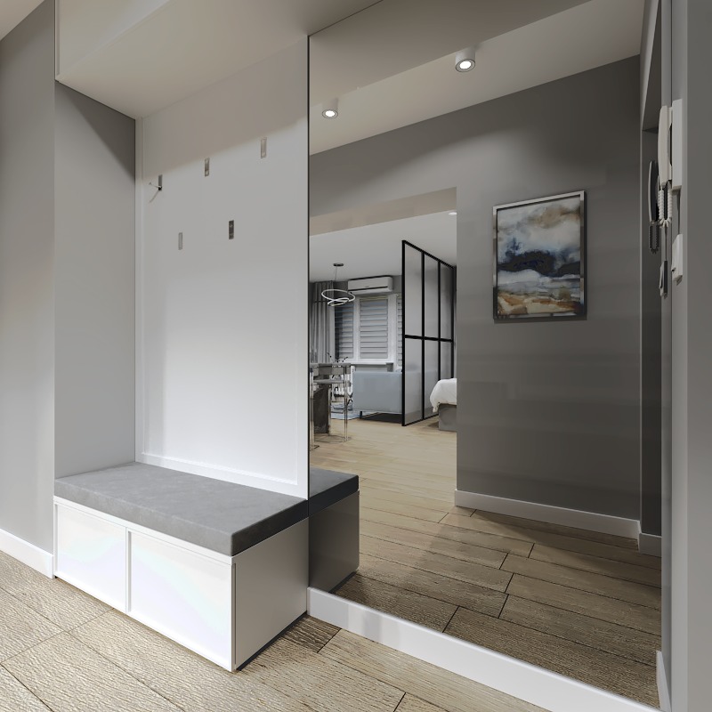 Nowoczesny przedpokój z siedziskiem, lustrem i widokiem na salon oddzielony czarną, przeszkloną ścianką działową.