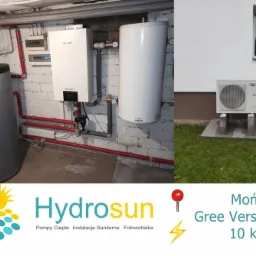 Instalacja grzewcza w kotłowni: zbiornik buforowy, jednostka wewnętrzna i zewnętrzna pompy ciepła Gree Versati Split 10kW, widoczne rury w kolorze czerwonym.