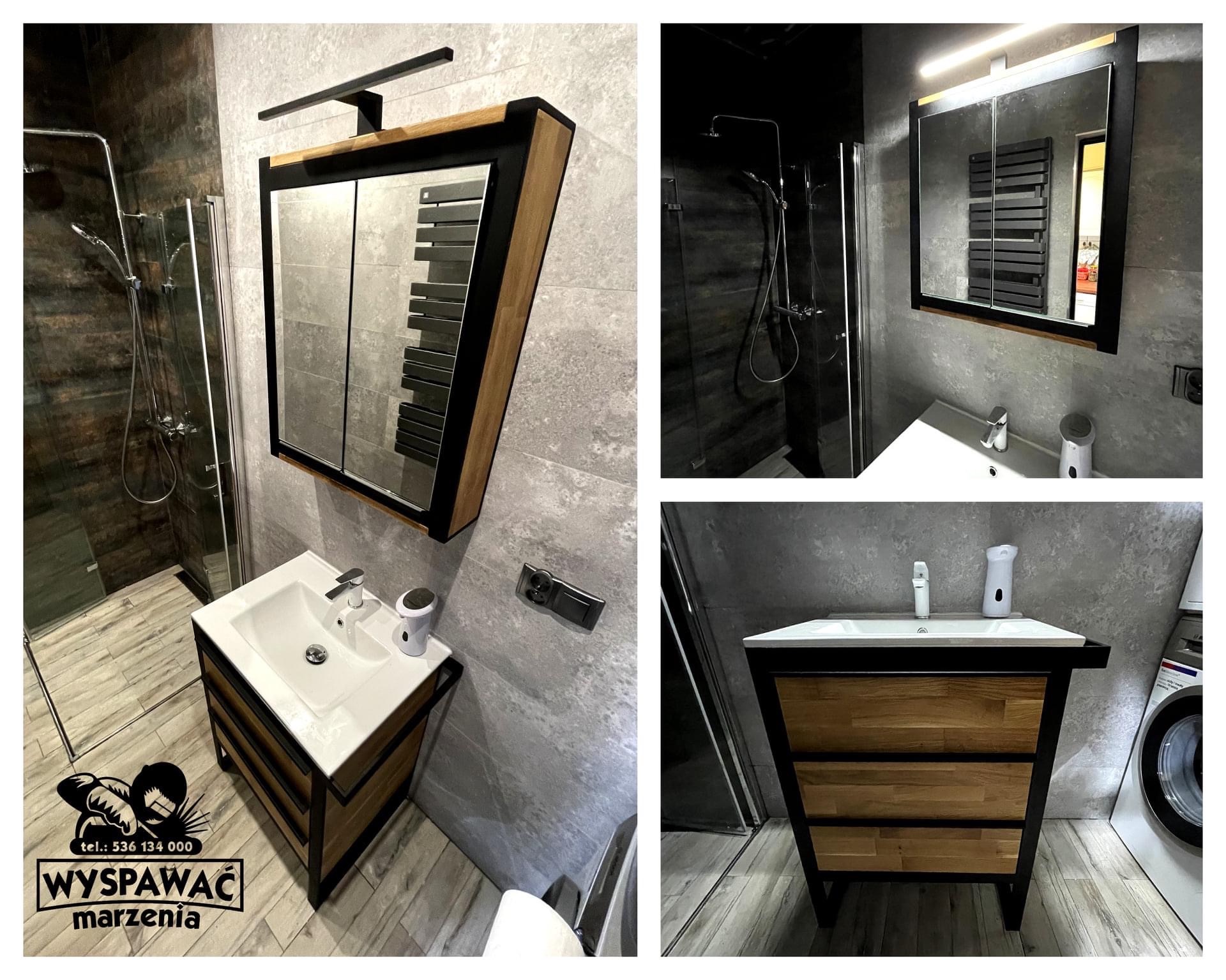 Nowoczesna łazienka w szarościach z umywalką i szafką z drewnianymi frontami w metalowej ramie oraz lustrem z szafką, widoczne logo firmy na podłodze.