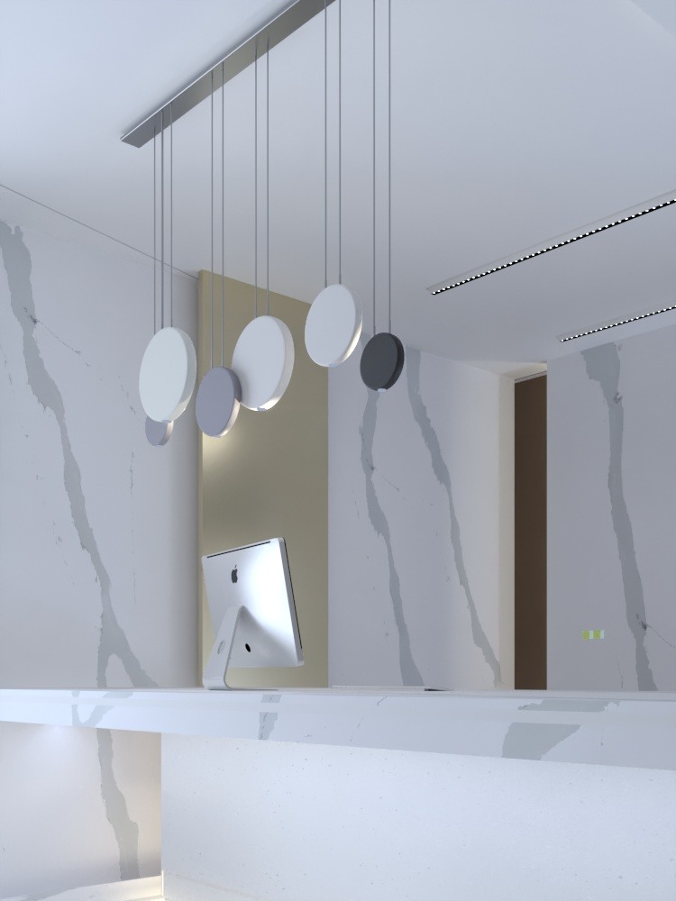 Recepcja biurowa z blatem z białego marmuru, komputerem iMac i nowoczesną lampą wiszącą z okrągłymi kloszami w odcieniach bieli i szarości.