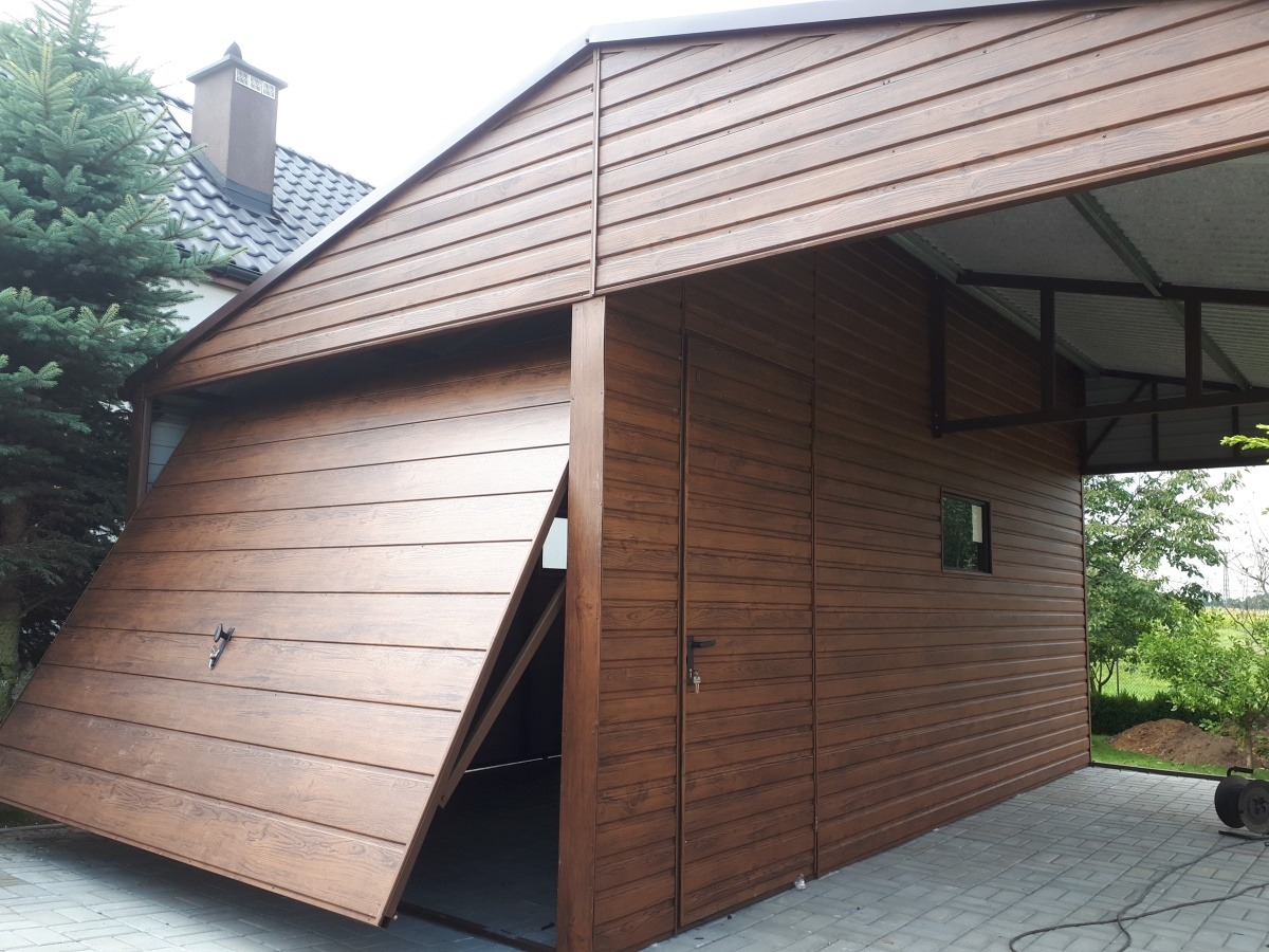 Nowoczesny garaż z bramą segmentową w kolorze drewna, częściowo otwarta, z widocznym zadaszeniem i elewacją z paneli imitujących drewno.