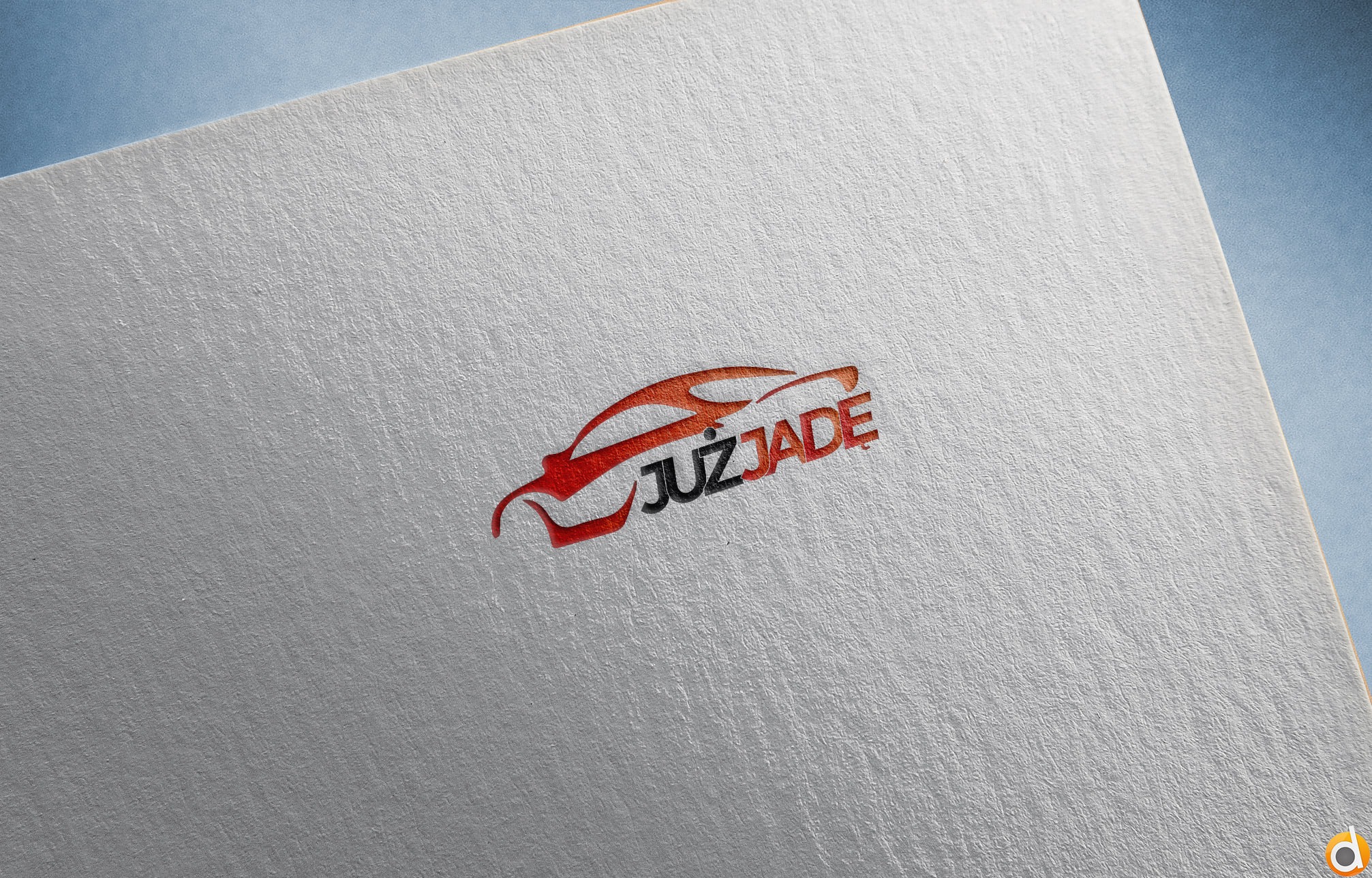 Logo firmy JUZJADE w kształcie stylizowanego czerwono-czarnego samochodu, umieszczone na białym papierze z widoczną fakturą.